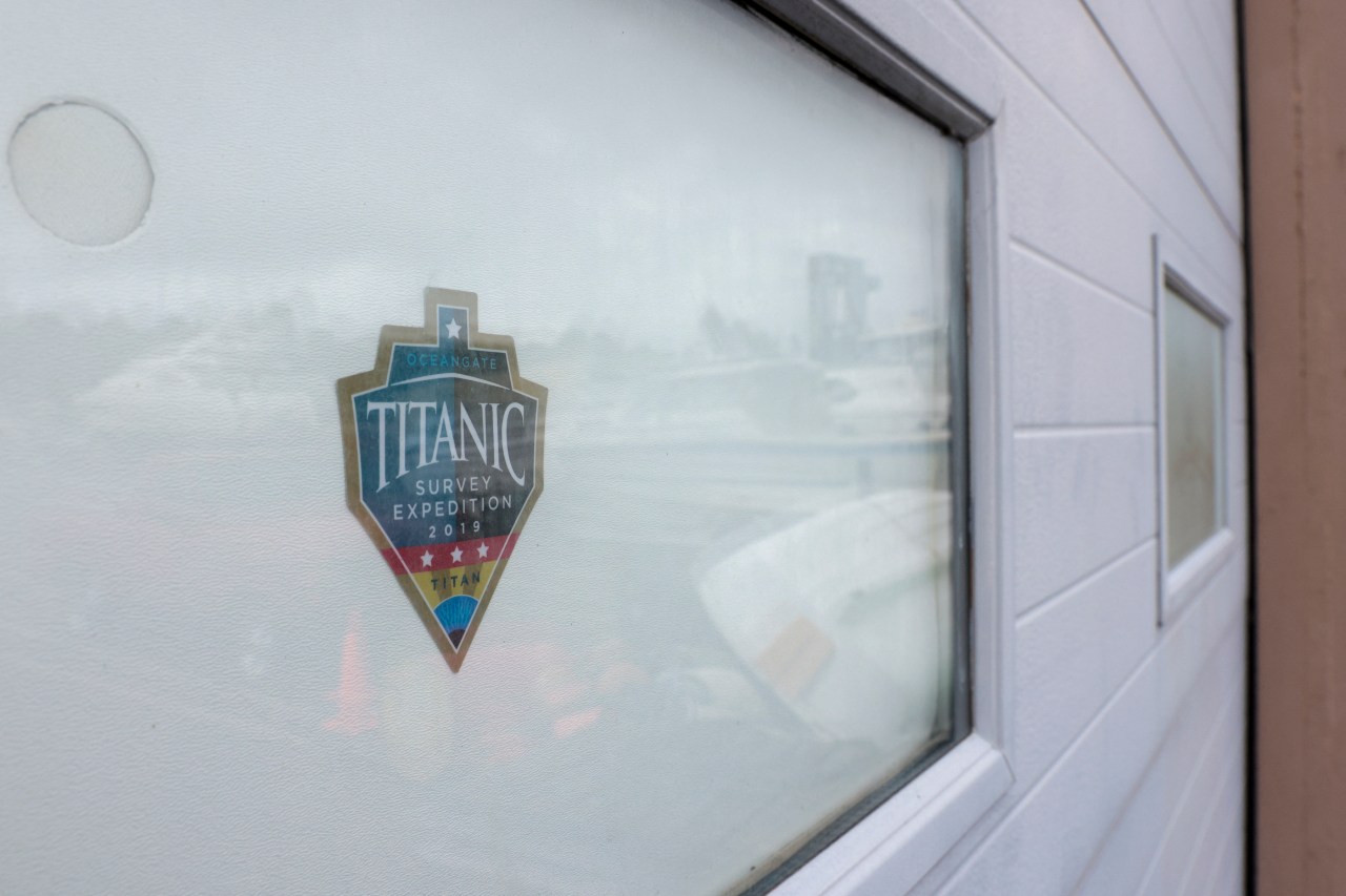 A decal reading "Titanic Survey Expedition 2019 Titan" on a window at OceanGate's facility in Everett, Washington