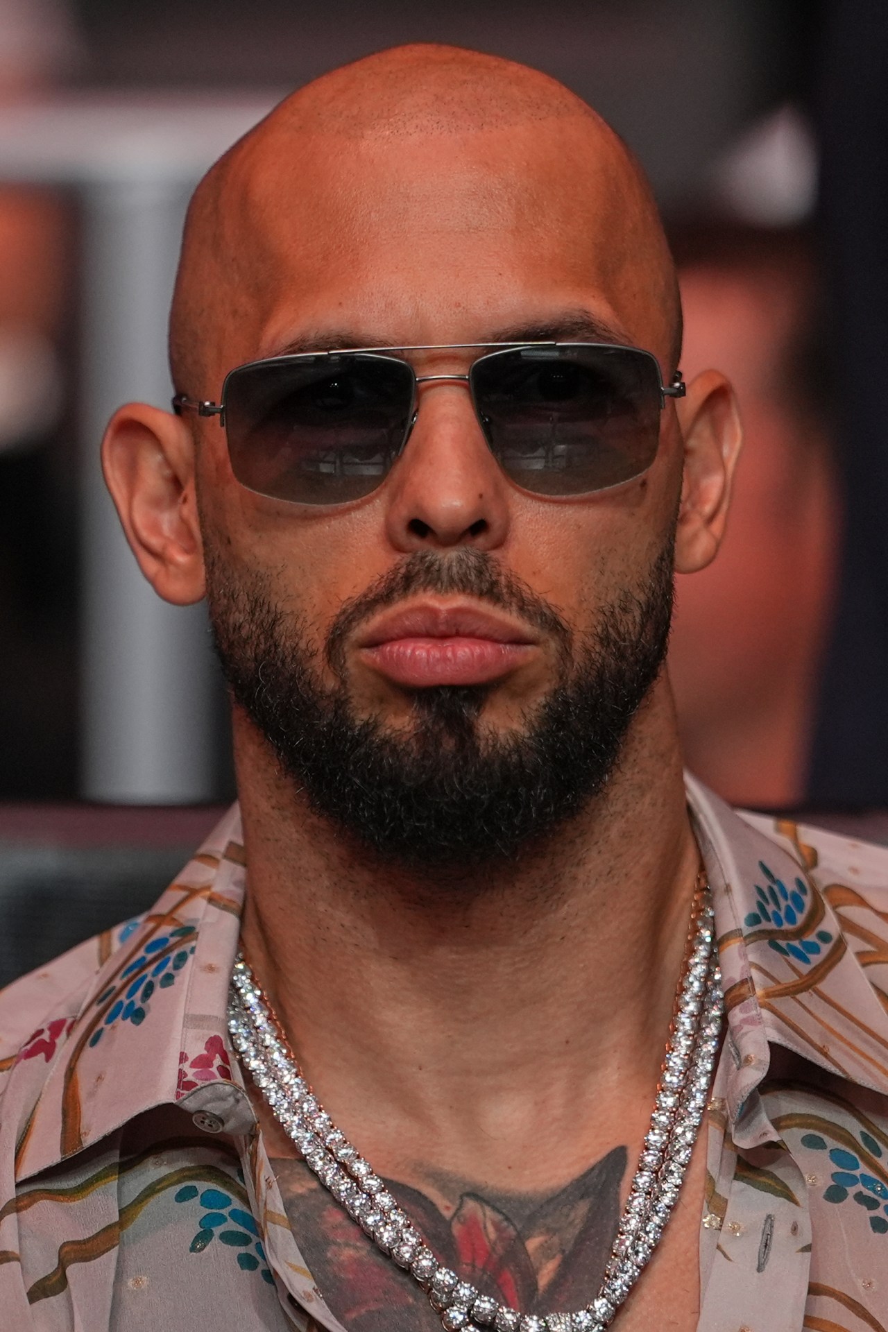 Andrew Tate seated at UFC 327 at Kaseya Center in Miami, Florida