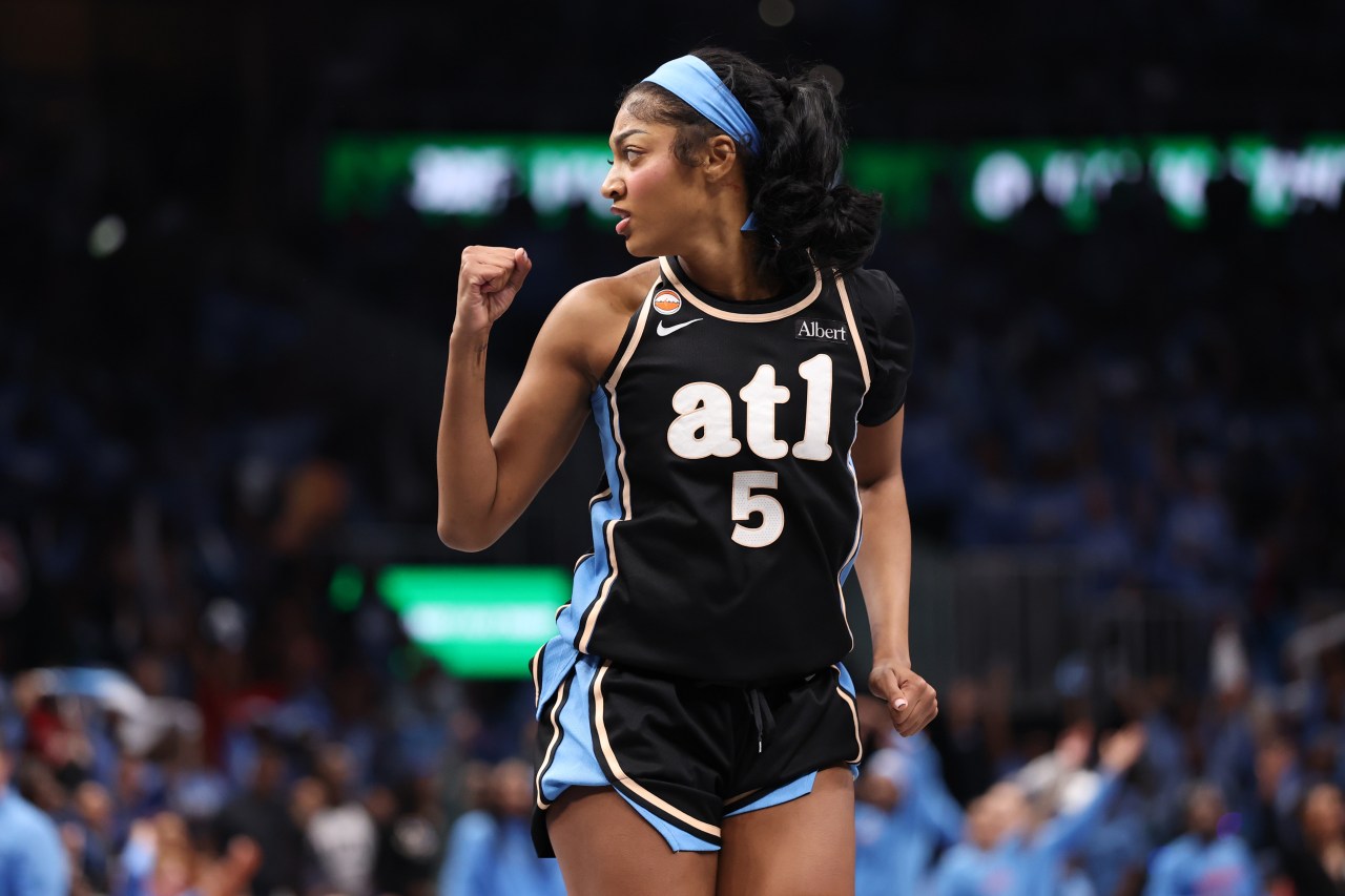 Angel Reese wearing Atlanta Dream jersey number 5 reacting during a WNBA Finals game at State Farm Arena