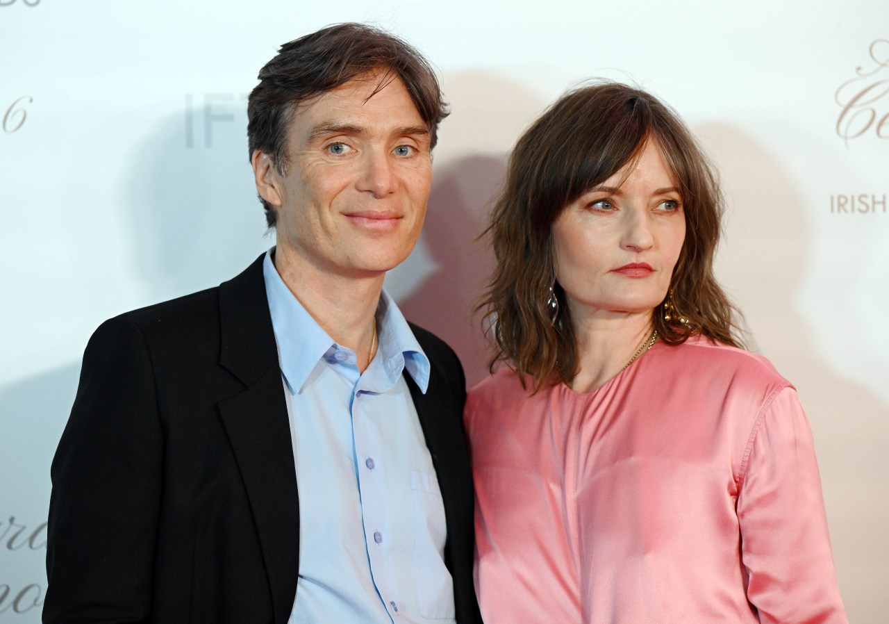 Cillian Murphy in a black blazer and light blue shirt standing beside Yvonne McGuinness in a pink satin top at an IFTA Awards event in Dublin.