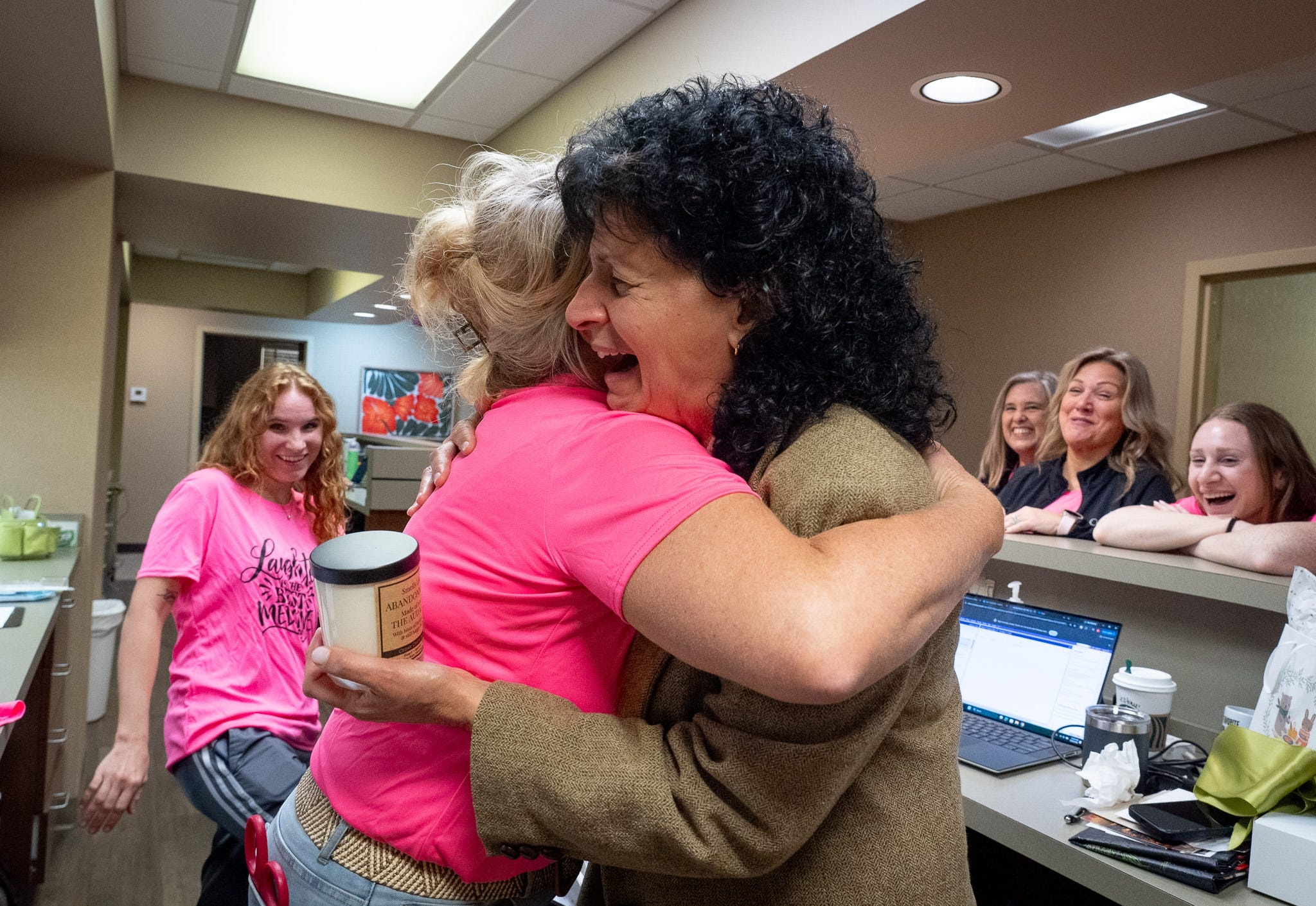 Rachel Clarke, practice manager, hugs Dr. Cecilia Ellis who retires after 37 years as an obstetrician and gynecologist at OBGYN Associates of Akron on Sept. 30, 2026.