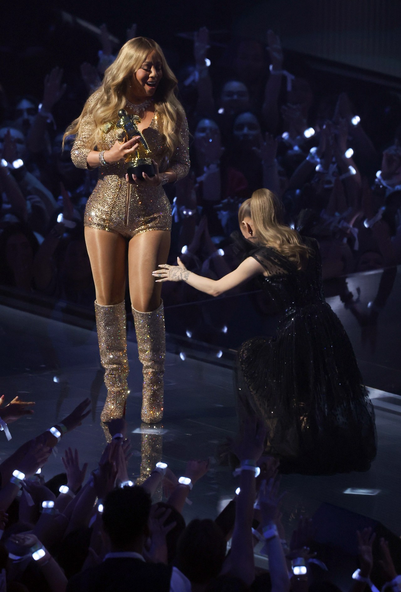 Mariah Carey accepting the Michael Jackson Video Vanguard Award from Ariana Grande at the 2025 MTV VMAs at UBS Arena