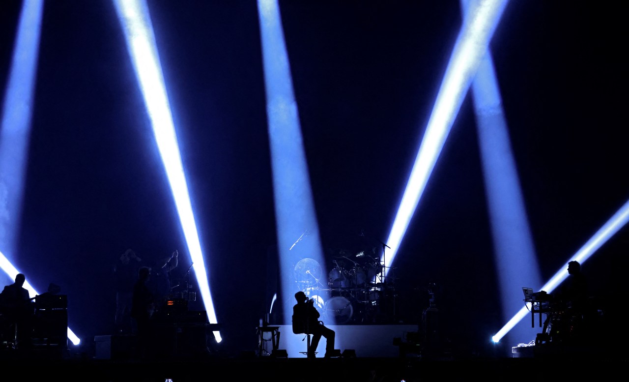 Phil Collins performing on stage with Genesis at Paris La Défense Arena in Nanterre, France