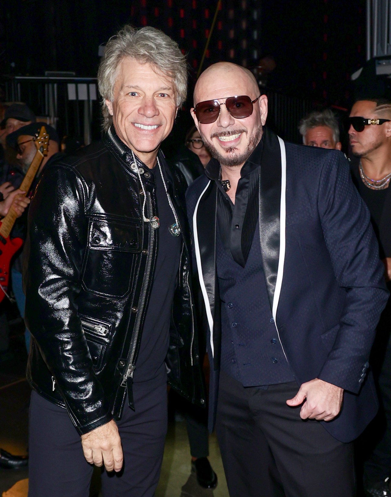 Jon Bon Jovi and Pitbull standing together backstage at the 25th Latin GRAMMY Awards