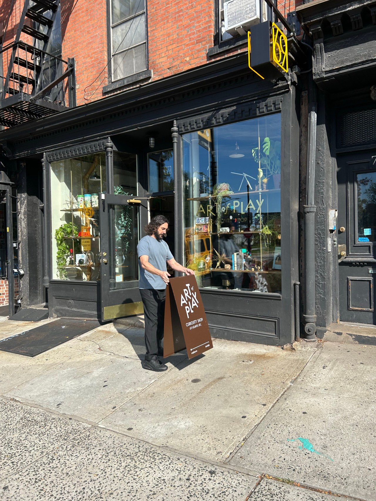 Adam Rubin, co-owner of Art of Play, standing outside his Brooklyn storefront