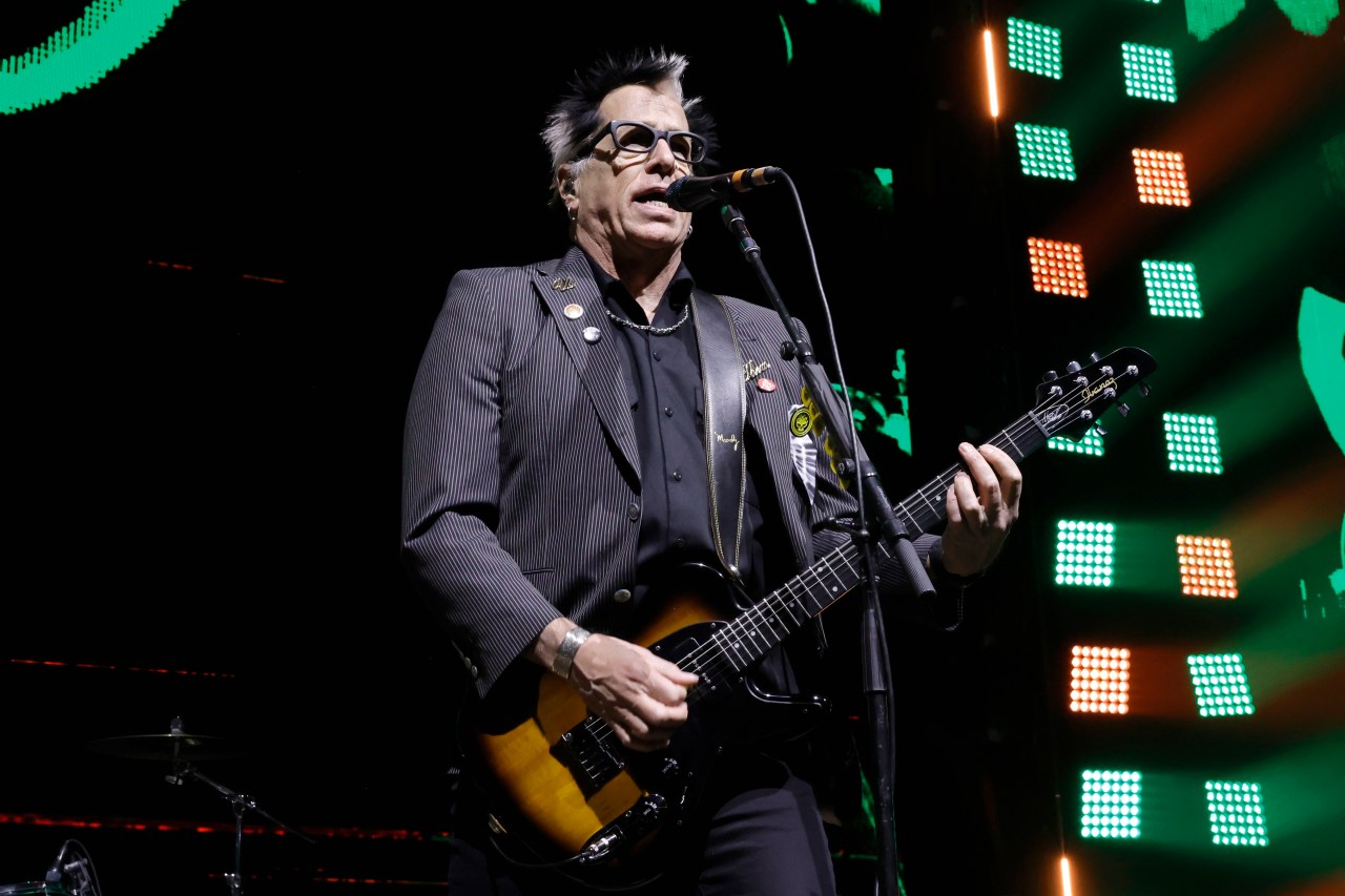 Kevin "Noodles" Wasserman of The Offspring performing onstage at the Kia Forum in Inglewood, California