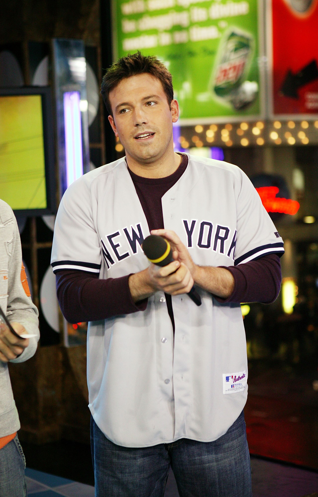 Ben Affleck wearing a New York Yankees uniform on stage at MTV's Total Request Live in Times Square
