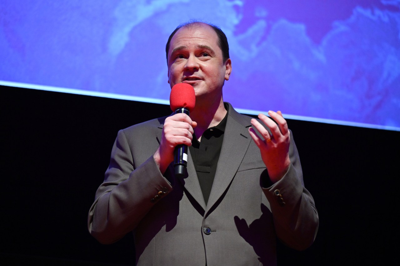 Mike Flanagan speaking onstage at a Q&A for The Life of Chuck at SXSW London 2025
