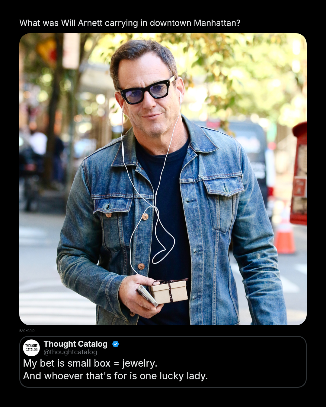 Will Arnett walking through downtown Manhattan holding a small wrapped present